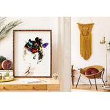 Butterfly art print set in a wooden frame atop a desk with a view to an art deco living room beyond