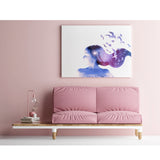 Freedom canvas art print mounted on a wall above a dusty pink velvet sofa with pink and white objects displayed on one side